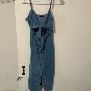 Blue denim dress with buttons and tie in the front